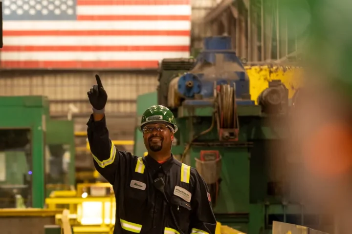 CNC technician operating five-axis machining center — technical talent in manufacturing at work.